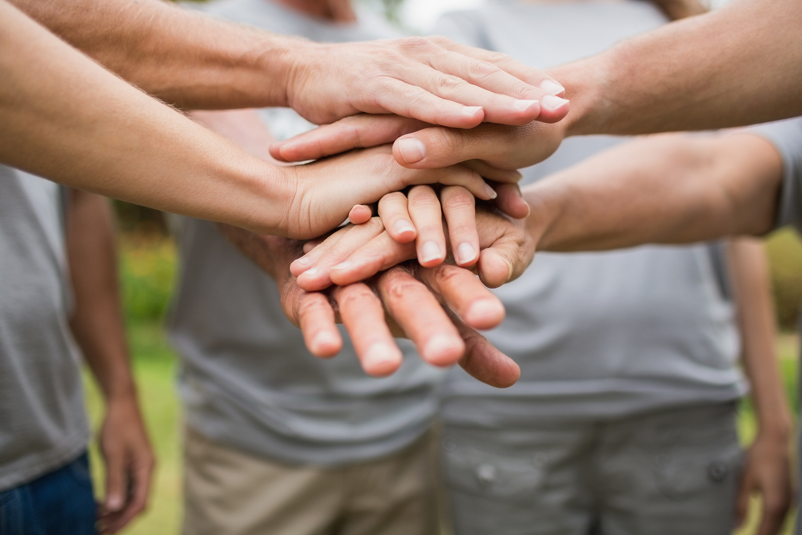 friends stacking hands in support