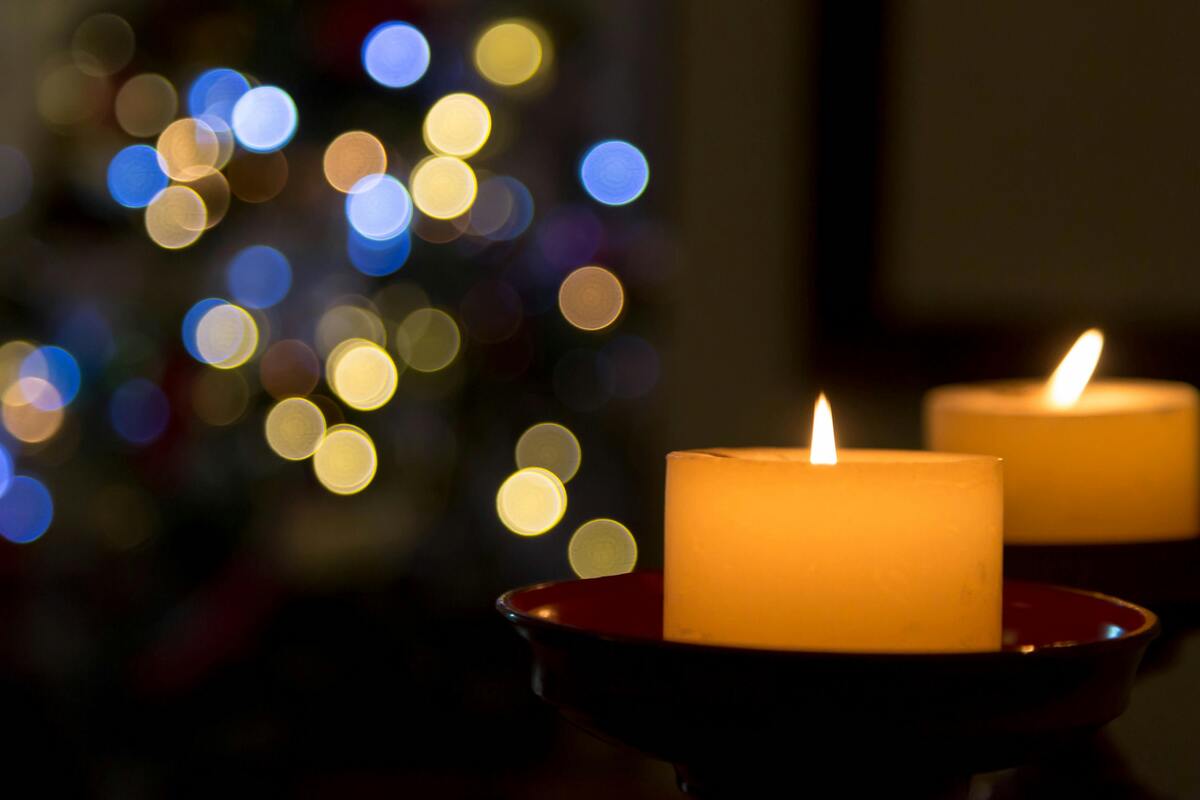 lit candles with glimmering light in the background