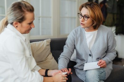 woman talking with a woman who was down