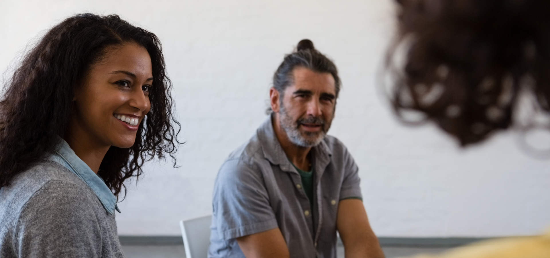 friends looking at man while sitting around a table